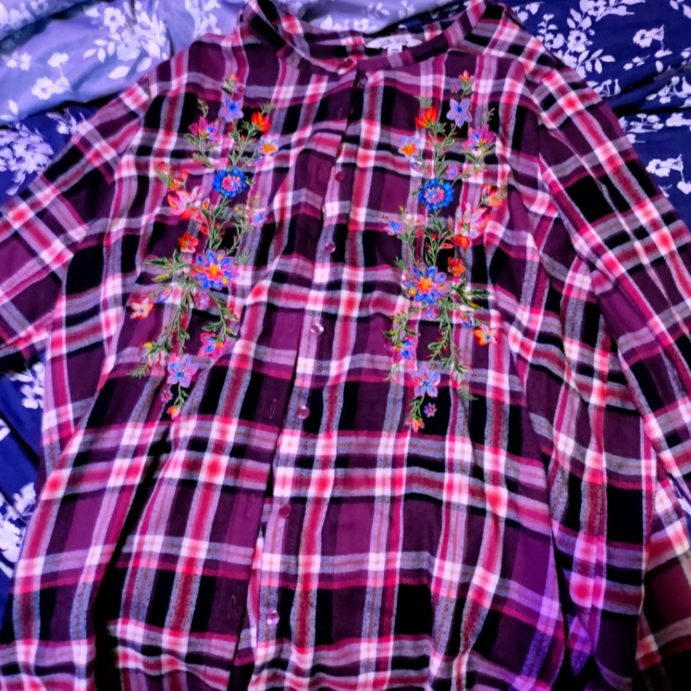 Plaid shirt with flowers on it.